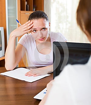 Unhappy woman filling questionnaire