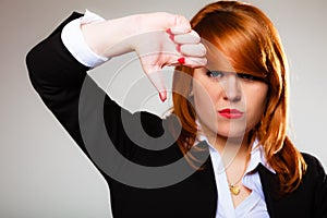 Unhappy woman giving thumb down gesture
