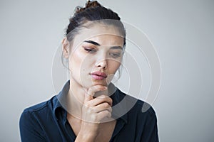 Unhappy woman on gray background