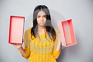 Unhappy woman holding empty gift box