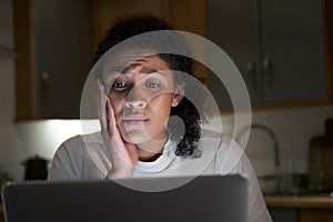 Unhappy Woman At Home With Computer Being Bullied Online On Social Media