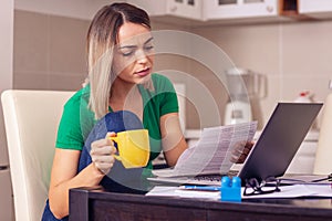 Unhappy woman at home planning family budget and finances.