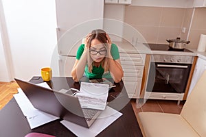 Unhappy woman at home planning family budget and finances