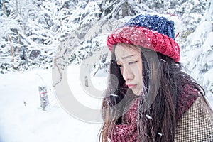 Unhappy woman with ice on skin very cold