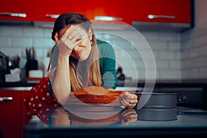 Unhappy Woman Making an Uneven Baked Birthday Sponge Cake