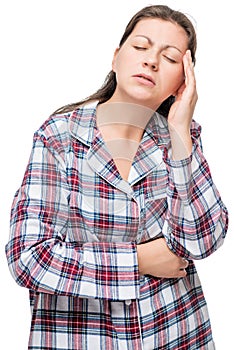 Unhappy woman in pajamas with a severe headache, on a white photo