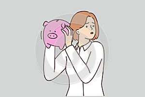 Unhappy woman with piggybank stressed with finances