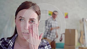 Unhappy woman`s face during divorce ,in the background of the moving box