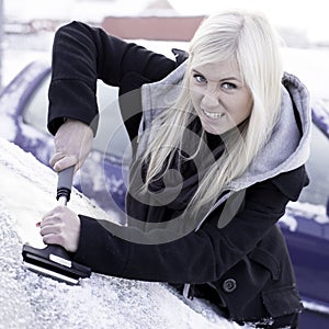 Unhappy woman scraping ice