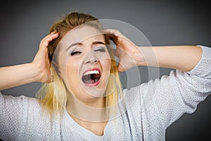 Unhappy woman screaming and yelling in pain