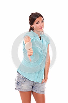 Unhappy woman in short jeans with thumb down