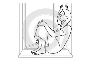 Unhappy woman sit on windowsill suffer from solitude