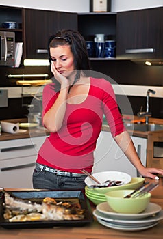 Unhappy woman standing in kitchen