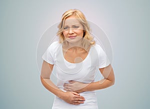 Unhappy woman suffering from stomach ache