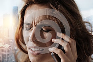 Unhappy woman talking on phone