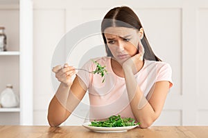 Unhappy Woman Tired Of Diet Eating Green Salad At Home