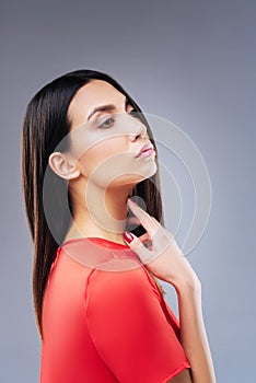 Unhappy woman touching her neck while having pain in it