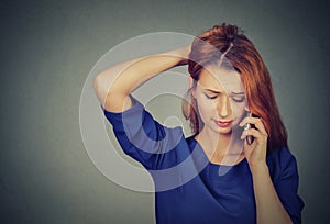 Unhappy worried woman talking on a phone