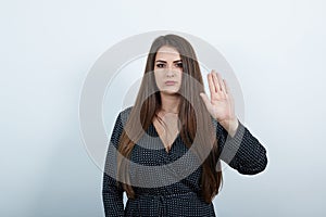Unhappy youg woman showing palms at camera, doing NO, stop gesture
