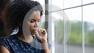 Unhappy young biracial woman feel lonely depressed at home