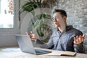 Unhappy young caucasian male worker in glasses look at laptop screen shocked by gadget breakdown or operational problems.