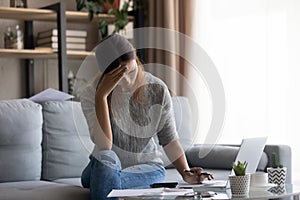 Unhappy young caucasian woman feeling stressed about lack of money.