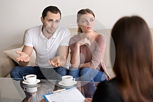 Unhappy young family couple with a problem at psychologist offic