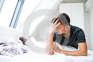 unhappy young heterosexual couple in bedroom