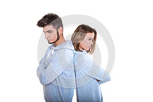 Unhappy young man and woman are standing back each other and not speaking