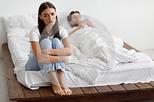 Unhappy Wife Suspecting Infidelity While Cheating Husband Texting In Bedroom photo