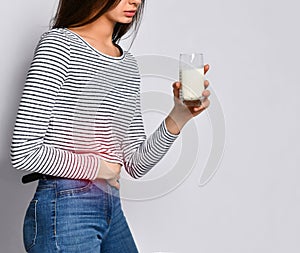 UNHappy young woman drinking milk