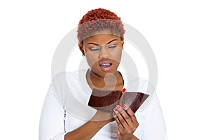 Unhappy young woman showing empty wallet