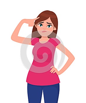 Unhappy young woman touching head while standing against white background. Woman holding fingers on her temples. Human emotion.