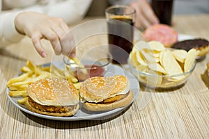 Unhealthy concept. A couple of friends are sitting at the table