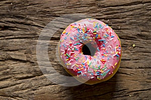 Unhealthy but delicious sweet sugar donut cake on vintage wooden table in lifestyle nutrition health care