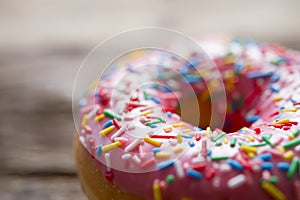 Unhealthy but delicious sweet sugar donut cake on vintage wooden table in lifestyle nutrition health care