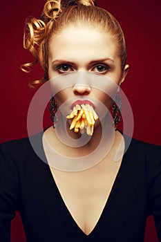 Unhealthy eating. Junk food concept. Arty portrait of woman with fries