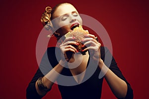 Unhealthy eating. Junk food concept. Guilty pleasure. Woman eating burger