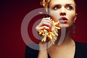 Unhealthy eating. Junk food concept. Portrait of woman with fries