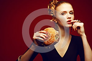 Unhealthy eating. Junk food concept. Woman eating burger