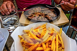 Unhealthy eating, pork steaks and french fries