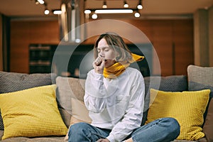 Unhealthy female cover mouth with hand while coughing, suffer grippe or bronchitis chronic disease sitting on couch photo