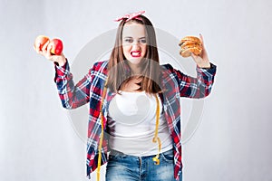 Unhealthy food fat woman concept, girl XXL between healthy and b