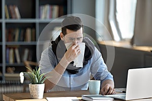 Unhealthy ill stressed young 30s businessman having first flu symptoms.