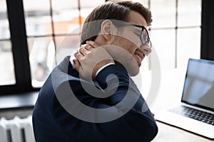 Unhealthy male employee suffer from neck muscular spasm