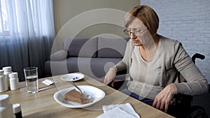 Unhealthy senior woman feeling pain in nursing home, refusing to eat, old age