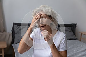 Unhealthy senior woman suffer from migraine at home