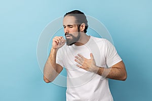 Unhealthy sick man having flu symptoms, coughing, keeping hand near mouth.