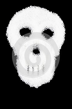 unhealthy white sugar concept-spilled white sugar crystals forming a skull