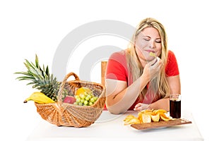 Unhealthy woman eating junk food rather than fruit